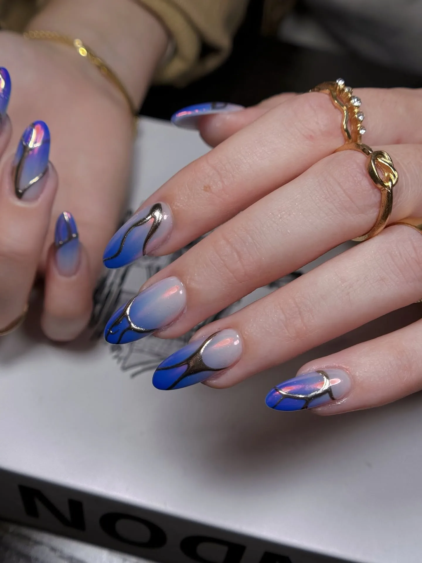 Blue aura chrome swirl nail art