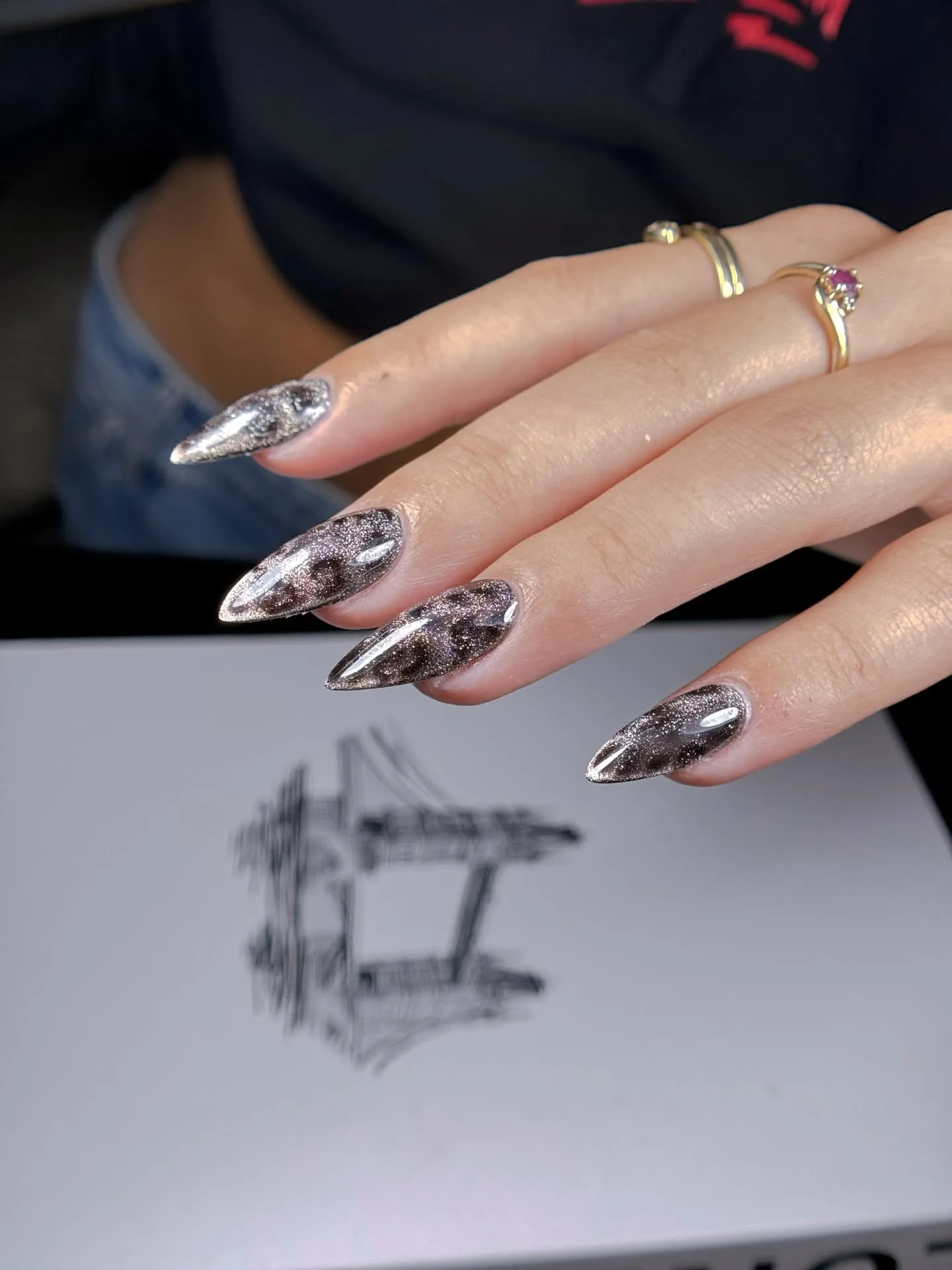 Bronze and charcoal glitter cat-eye stiletto nails